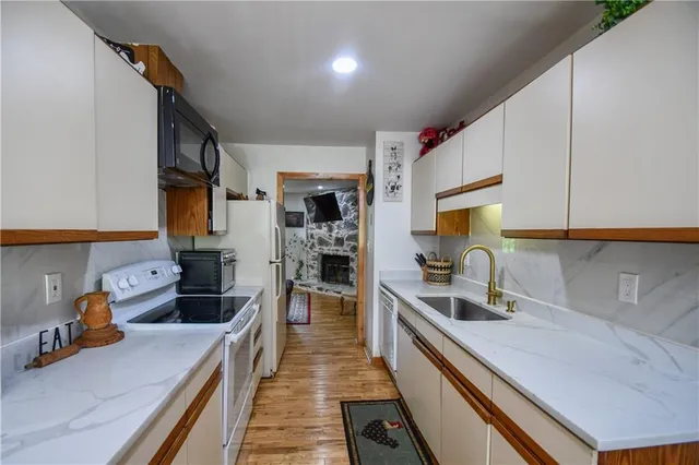 a living room with furniture a floor to ceiling window and a rug