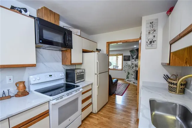 a living room with furniture a rug and a large window