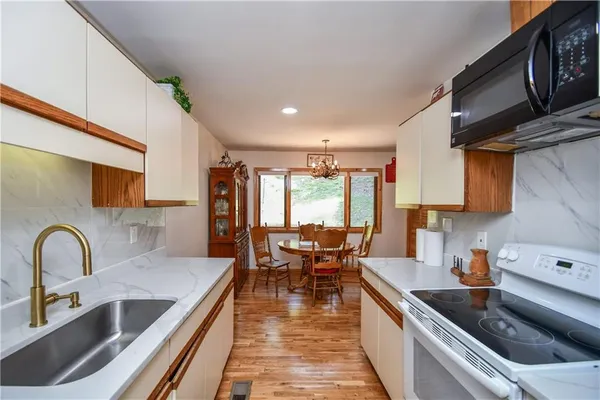 a living room with furniture ceiling fan and a rug