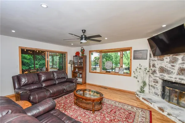 a living room with furniture and a floor to ceiling window