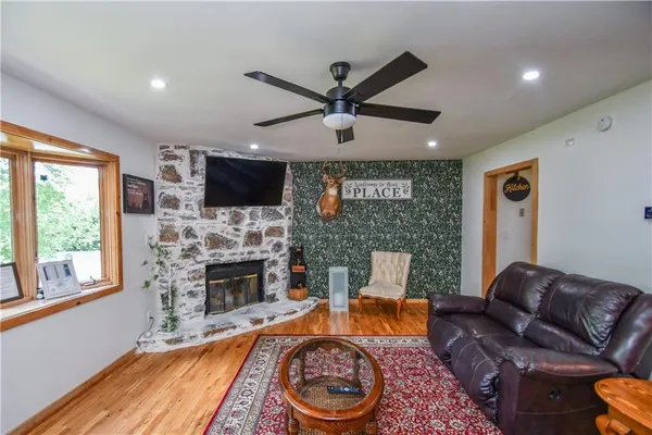 a living room with furniture a fireplace and a flat screen tv