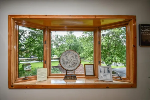 a bedroom with a bed and dresser with mirror