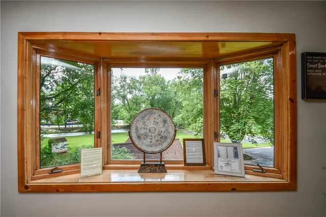 a bedroom with a bed and dresser with mirror