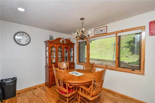 a view of a dining room with furniture wooden floor and chandelier