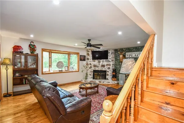a view of a big house with a big yard and large trees