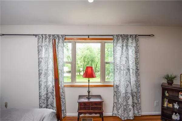 a view of a park with a bench and trees