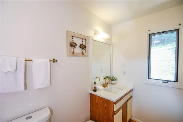 a view of a big house with a big yard and large trees