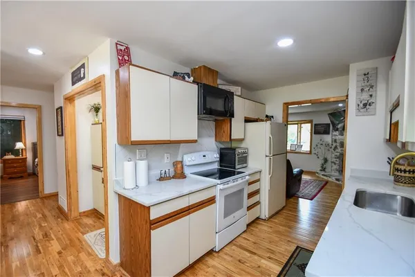 a kitchen with stainless steel appliances granite countertop a refrigerator stove and sink