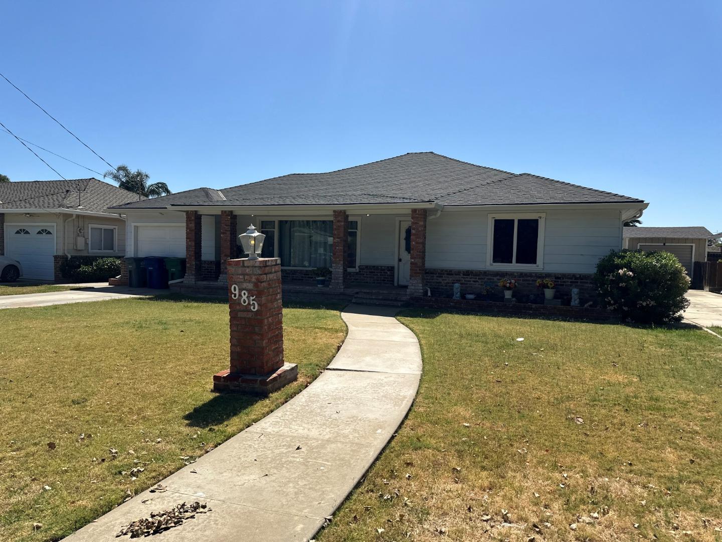 985 Grove Avenue Gustine, CA 95322 - Photo 3 of 14 a front view of a house with swimming pool