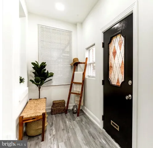 a view of a livingroom with furniture and a floor to ceiling window