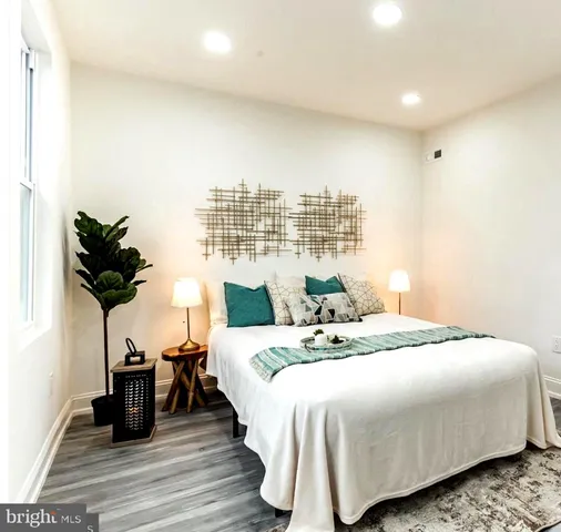 a bedroom with a bed and a potted plant