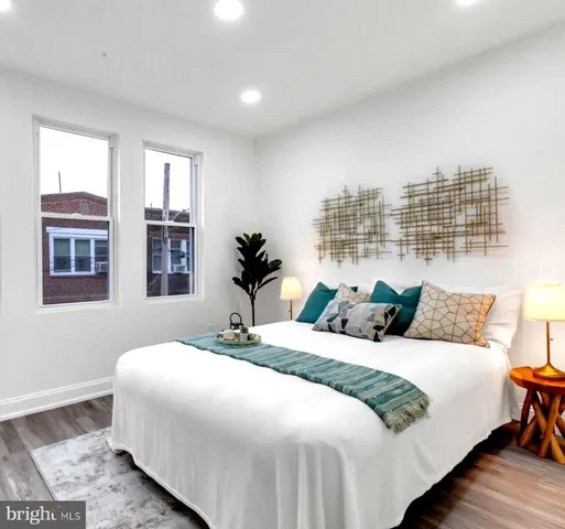 a bedroom with a large bed and a lamp