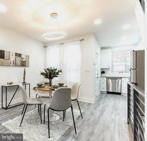 a view of a dining room with furniture and a chandelier