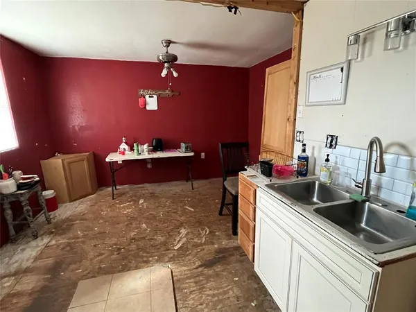a kitchen with a sink and a refrigerator