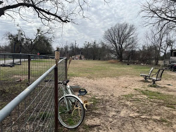 a view of a wooden deck with chairs and a yard