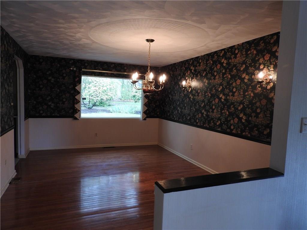 110 Rays Road Fenelton, PA 16034 - Photo 16 of 25 Formal Dining Room with hardwood floors, chair rail and a large picture window with a panoramic view of the treeline back yard.