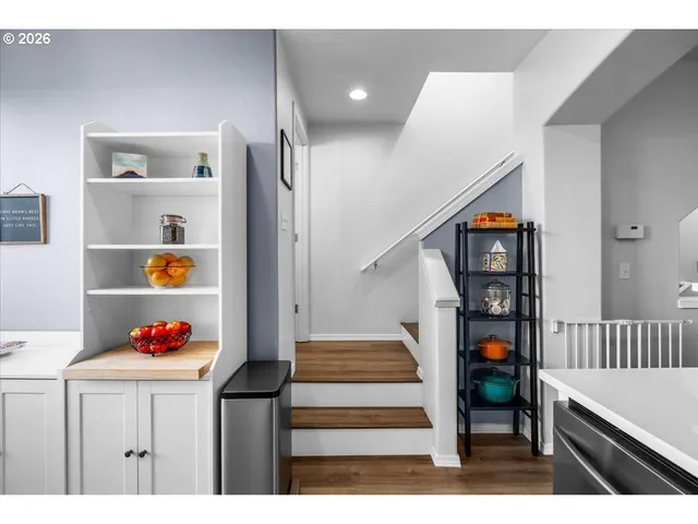 a hallway with a book shelf and lounge chair