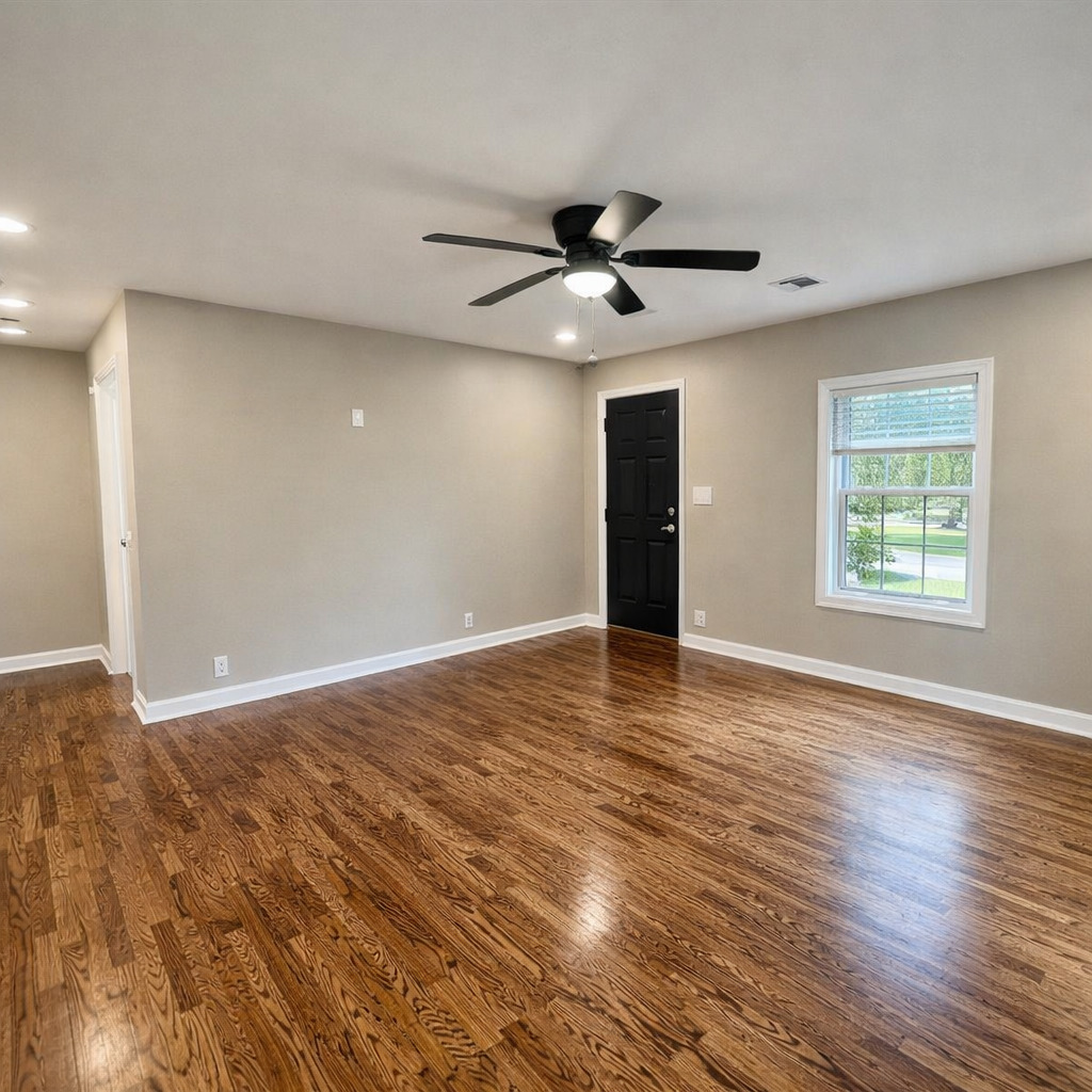 314 West 12th Street Metropolis, IL 62960 - Photo 15 of 29 a view of an empty room with wooden floor and a window
