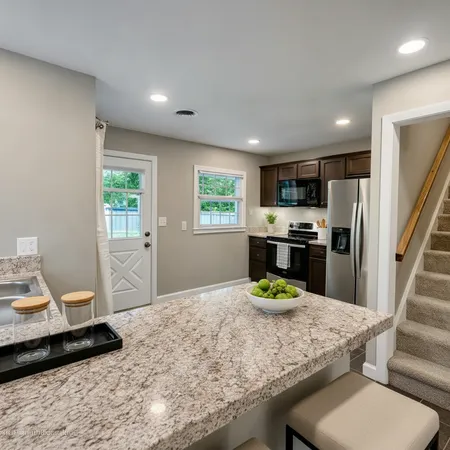a kitchen with a sink appliances and cabinets