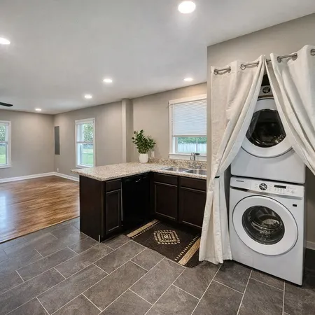 a kitchen with stainless steel appliances granite countertop a stove a sink and a microwave