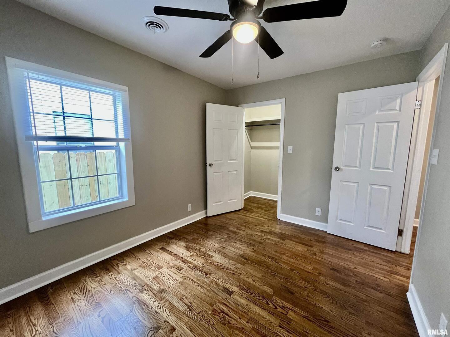 314 West 12th Street Metropolis, IL 62960 - Photo 28 of 29 an empty room with wooden floor cabinet and windows