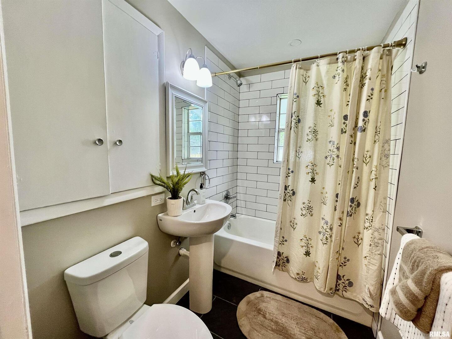 314 West 12th Street Metropolis, IL 62960 - Photo 29 of 29 a bathroom with a sink a toilet a mirror and shower curtain