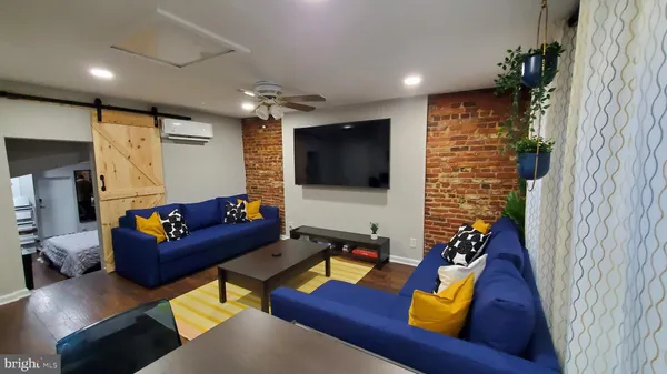 a living room with furniture and a flat screen tv