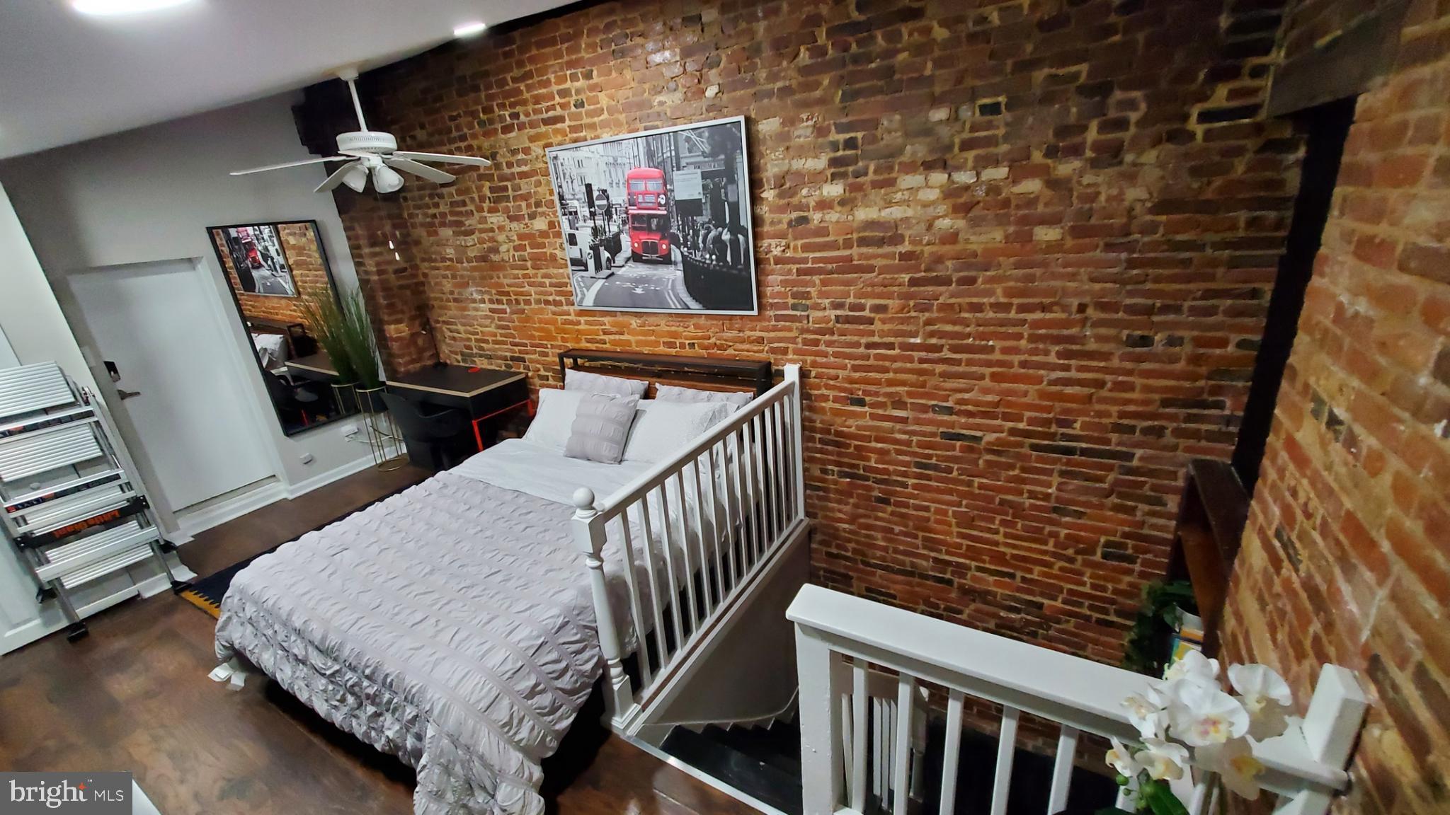 244 South Exeter Street, Unit 3 Baltimore, MD 21202 - Photo 7 of 18 a bedroom with a bed and a wall painting
