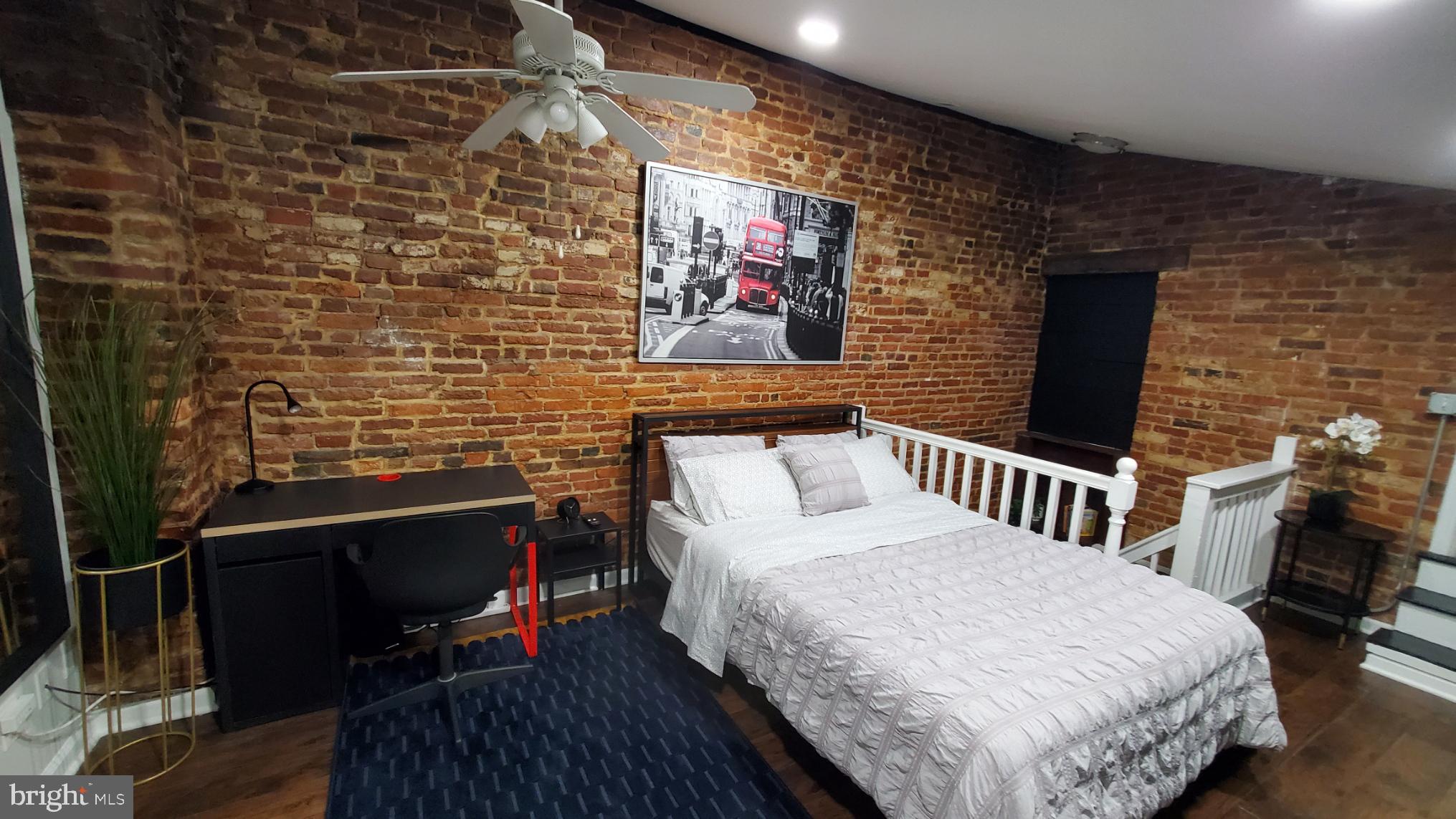 244 South Exeter Street, Unit 3 Baltimore, MD 21202 - Photo 9 of 18 a bedroom with a bed and a desk