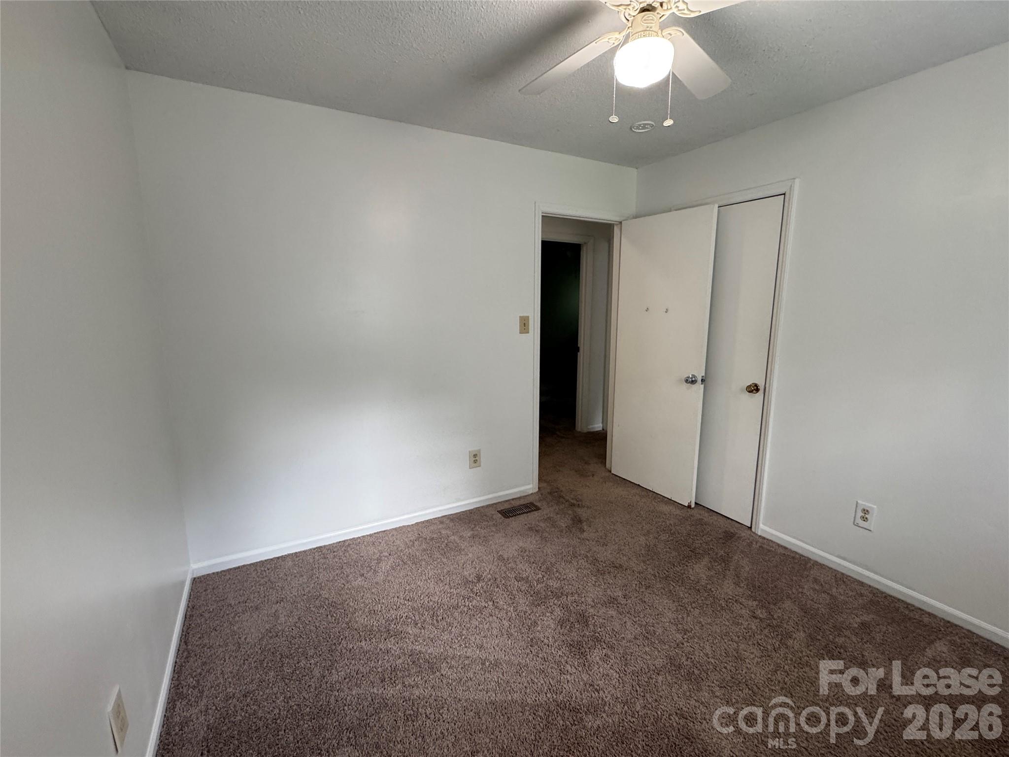 315 Pine Road Mount Holly, NC 28120 - Photo 14 of 21 an empty room with a ceiling fan and a window