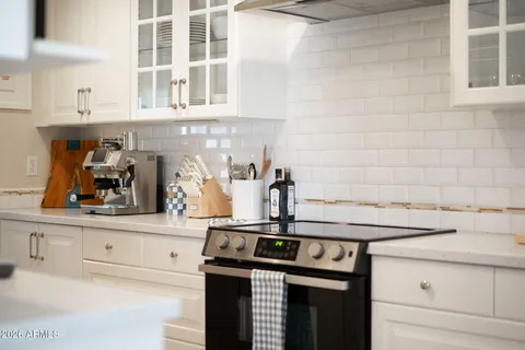 a kitchen with stainless steel appliances granite countertop a sink and cabinets