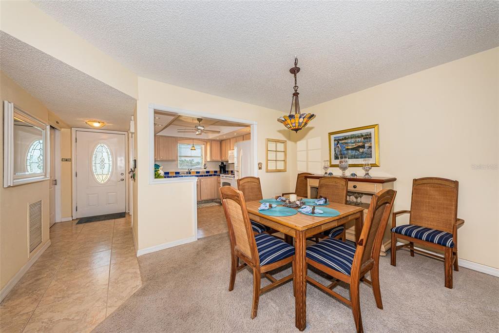 4750 Cove Circle, Unit 303 St. Petersburg, FL 33708 - Photo 13 of 64 a dining room with furniture and window