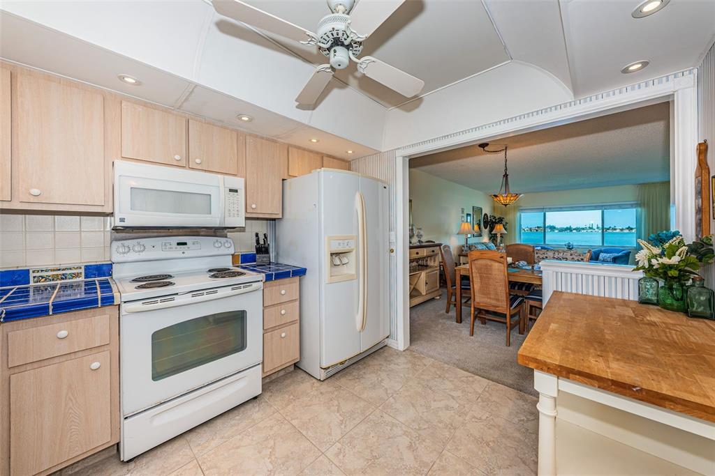 4750 Cove Circle, Unit 303 St. Petersburg, FL 33708 - Photo 2 of 64 a kitchen with a stove a refrigerator and a sink