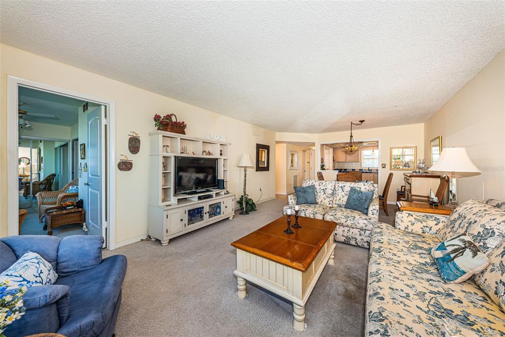 4750 Cove Circle, Unit 303 St. Petersburg, FL 33708 - Photo 22 of 64 a living room with furniture and a flat screen tv