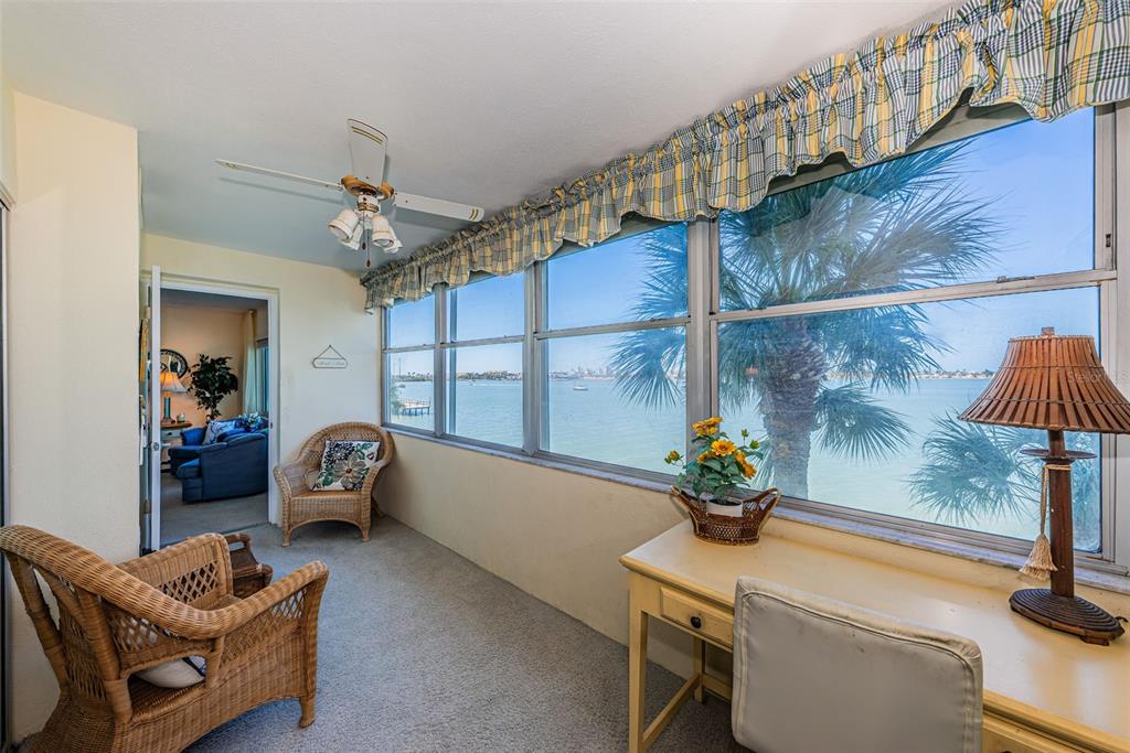 4750 Cove Circle, Unit 303 St. Petersburg, FL 33708 - Photo 34 of 64 a dining room with furniture and a chandelier