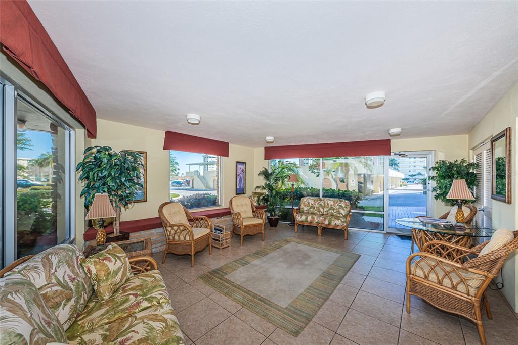 4750 Cove Circle, Unit 303 St. Petersburg, FL 33708 - Photo 43 of 64 a living room with furniture and a large window