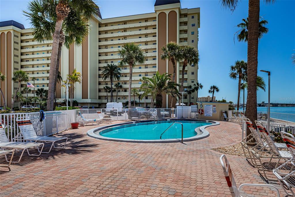4750 Cove Circle, Unit 303 St. Petersburg, FL 33708 - Photo 48 of 64 a front view of a building with outdoor seating