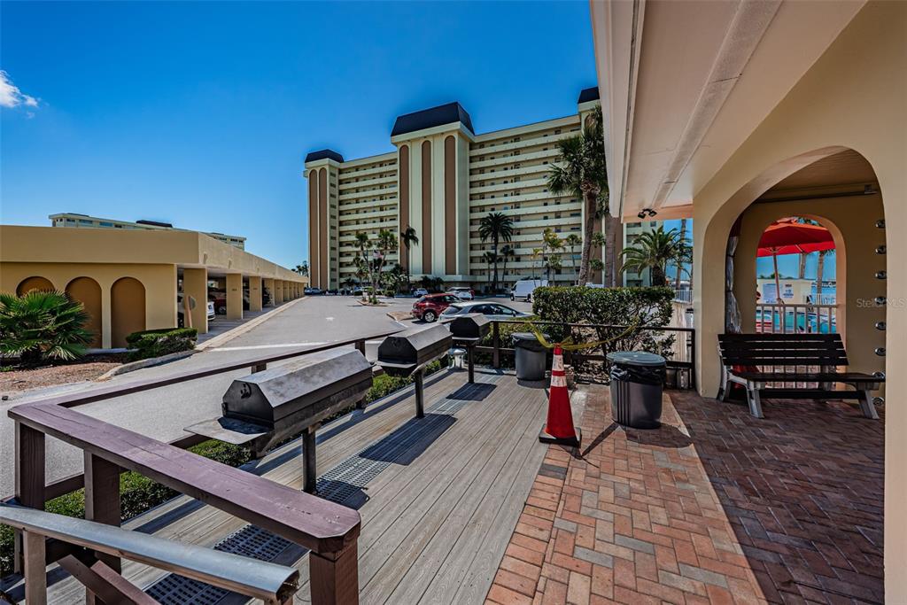 4750 Cove Circle, Unit 303 St. Petersburg, FL 33708 - Photo 52 of 64 a view of a balcony with chairs and wooden floor