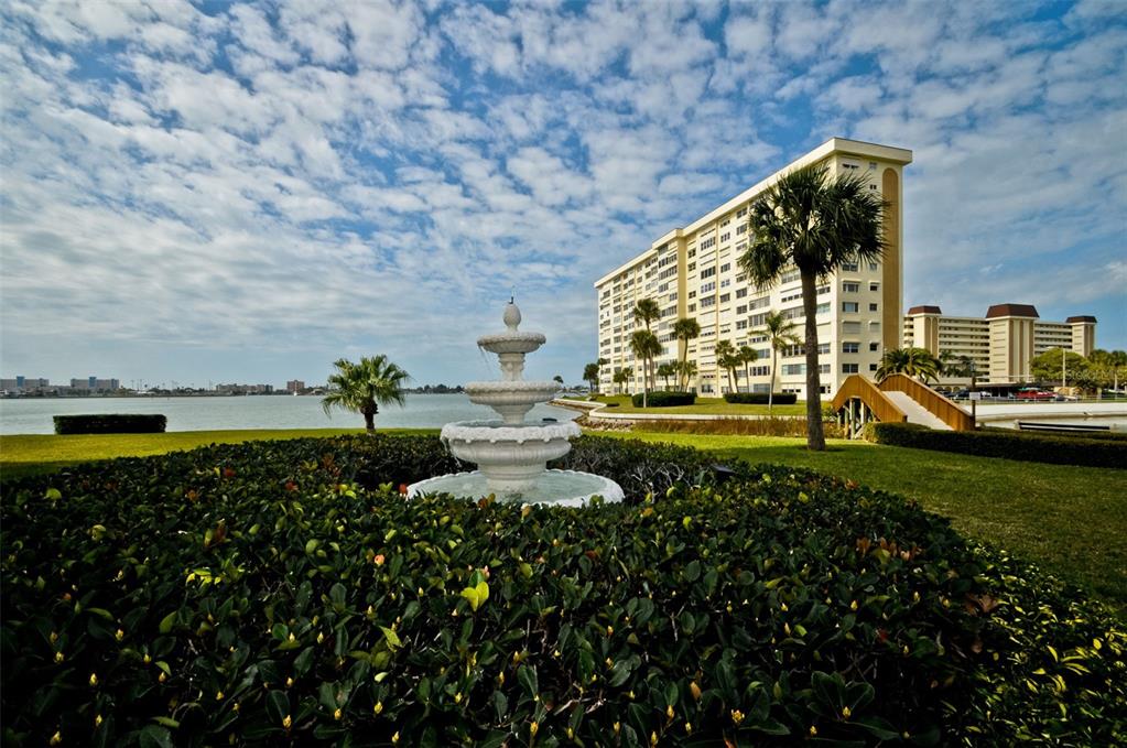 4750 Cove Circle, Unit 303 St. Petersburg, FL 33708 - Photo 59 of 64 a view of a lake with a building in the background