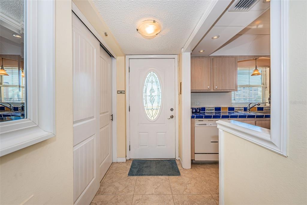 4750 Cove Circle, Unit 303 St. Petersburg, FL 33708 - Photo 6 of 64 a kitchen with a refrigerator and white cabinets