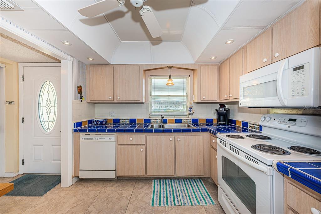 4750 Cove Circle, Unit 303 St. Petersburg, FL 33708 - Photo 8 of 64 a kitchen with a sink cabinets and window