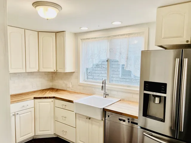 a kitchen with stainless steel appliances a refrigerator sink and cabinets