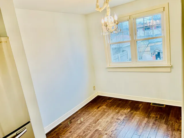 a view of room with window and wooden floor