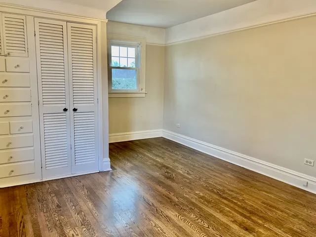 a view of a livingroom with wooden floor and a flat screen tv