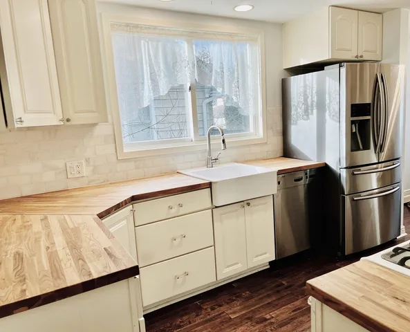 a view of kitchen with stainless steel appliances a refrigerator and a stove