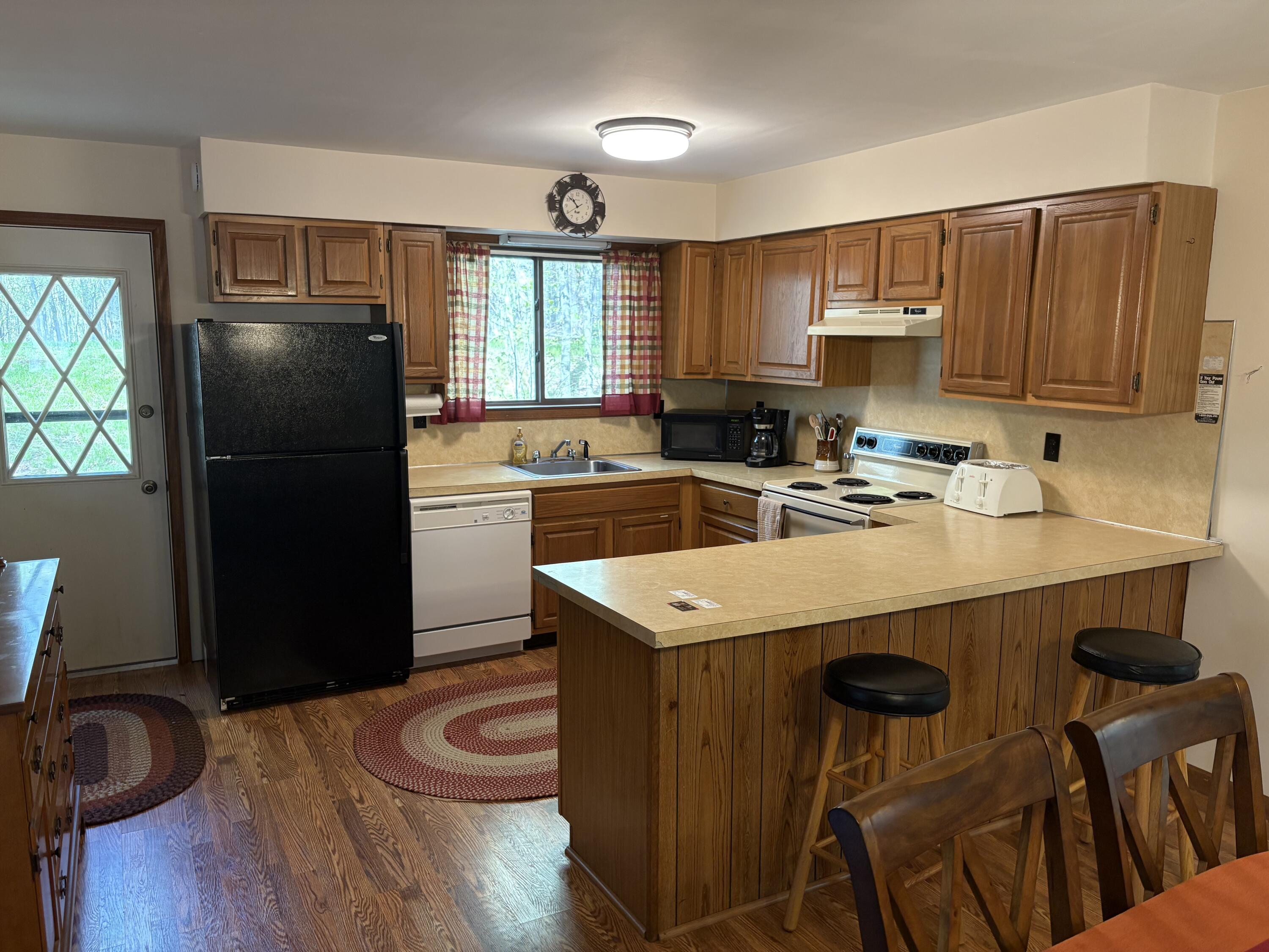 368 Ridge Road Pocono Lake, PA 18347 - Photo 12 of 42 a kitchen with a refrigerator a stove a sink dishwasher and cabinets