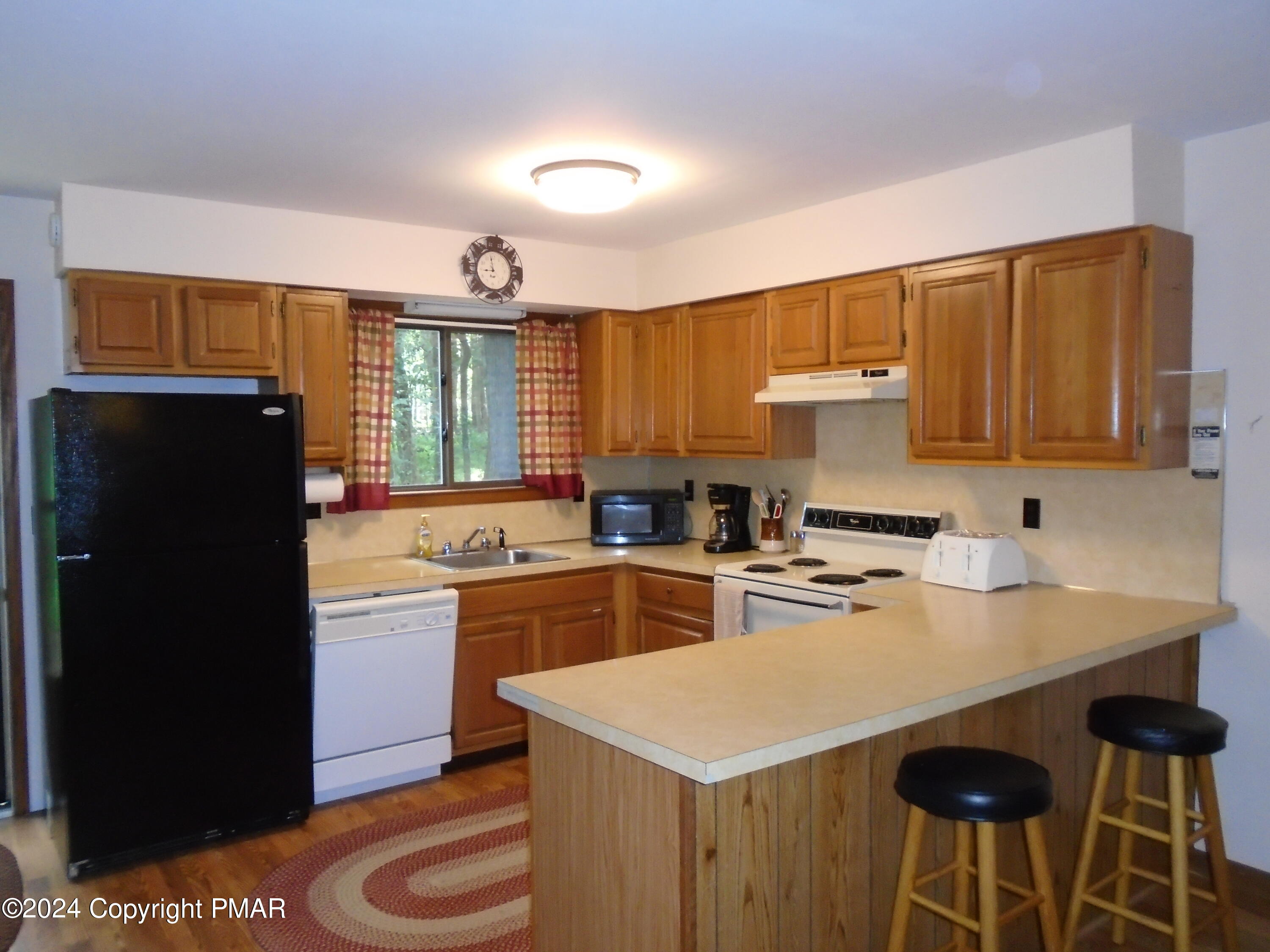 368 Ridge Road Pocono Lake, PA 18347 - Photo 17 of 42 a kitchen with a stove a refrigerator and a sink