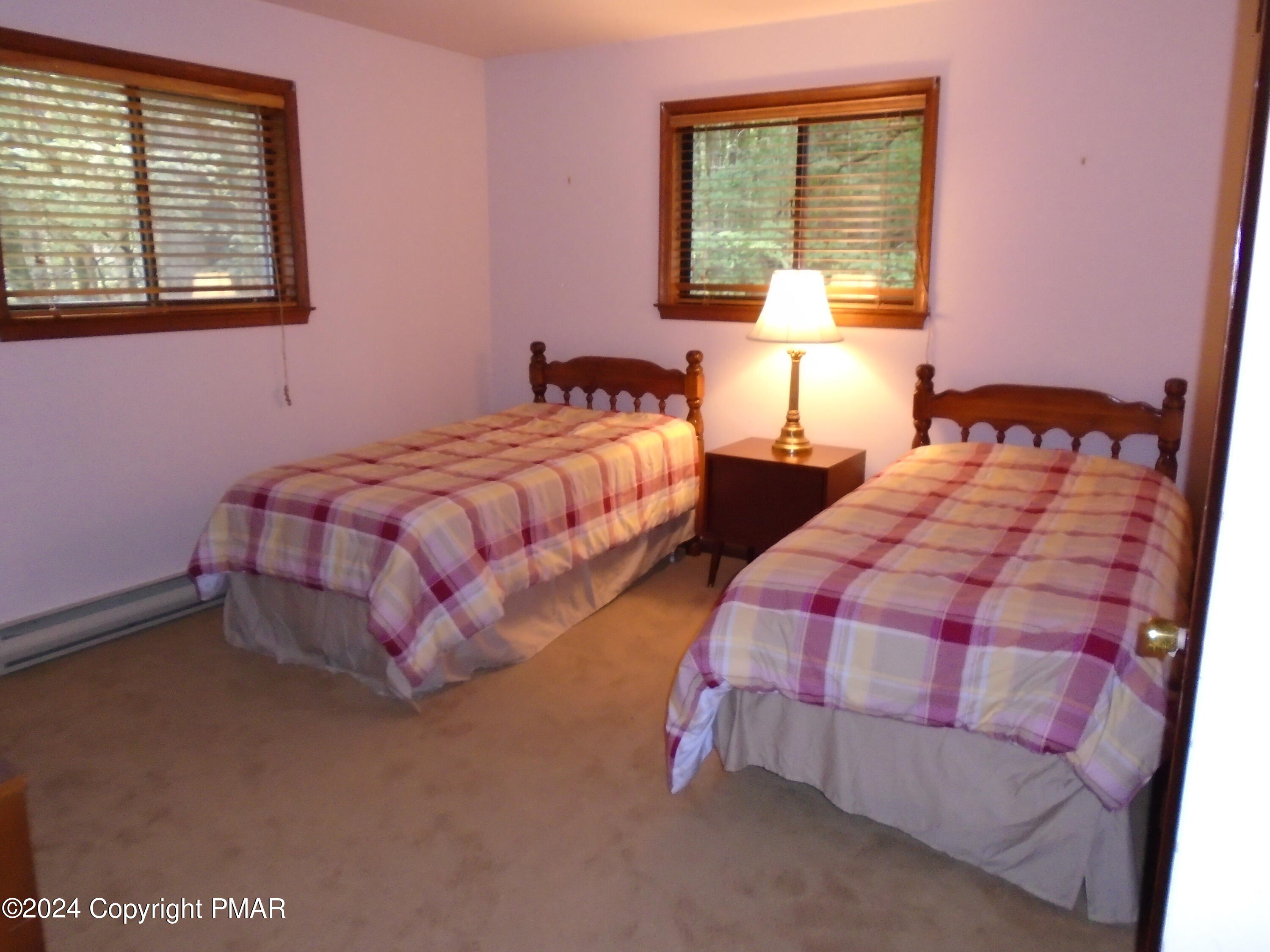368 Ridge Road Pocono Lake, PA 18347 - Photo 23 of 42 a bedroom with two beds and a window
