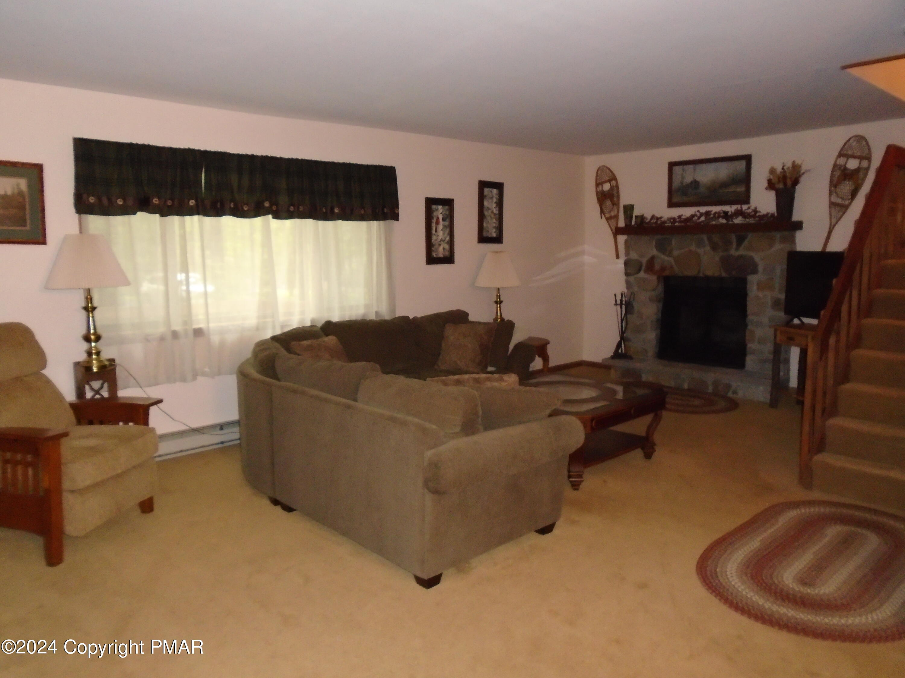 368 Ridge Road Pocono Lake, PA 18347 - Photo 8 of 42 a living room with furniture and a flat screen tv