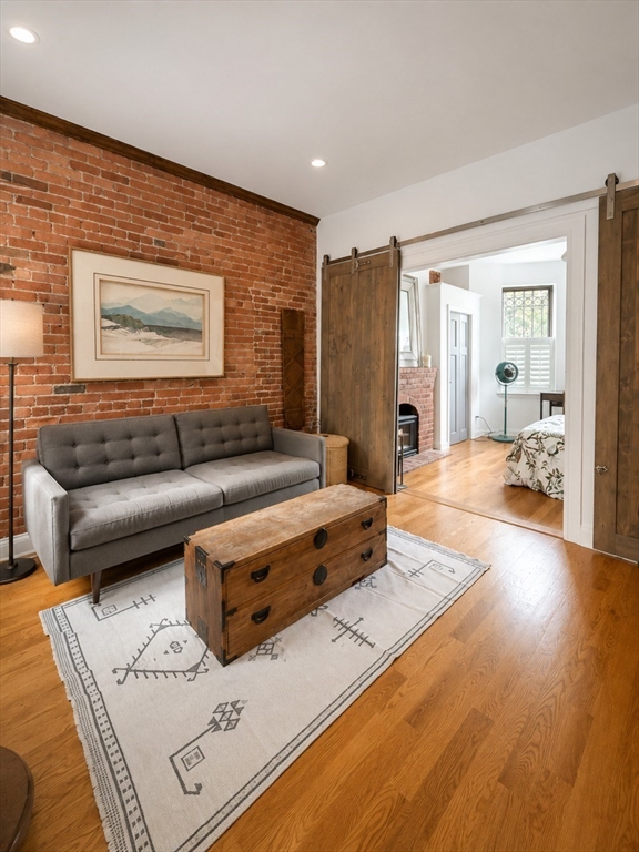9 Albemarle Street, Unit 2 Boston, MA 02115 - Photo 1 of 11 a living room with furniture and a wooden floor